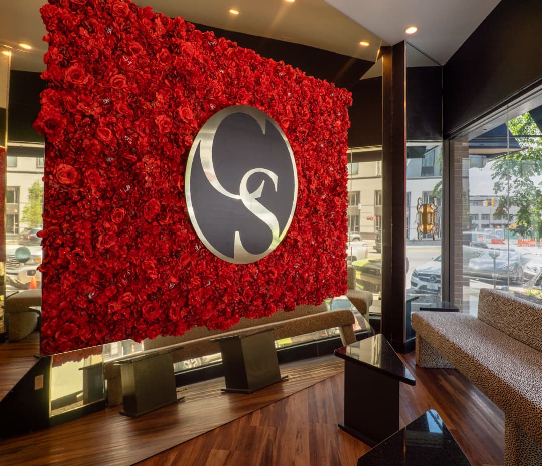 Cosmo Salon Studios flower wall and logo