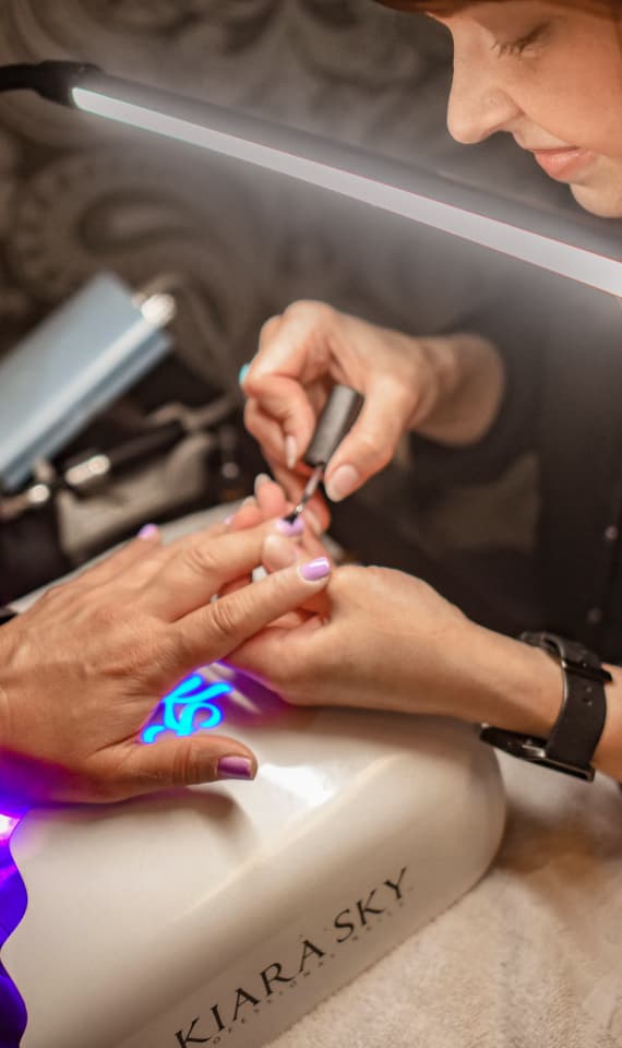 Beauty professional serving a client inside a private Cosmo studio