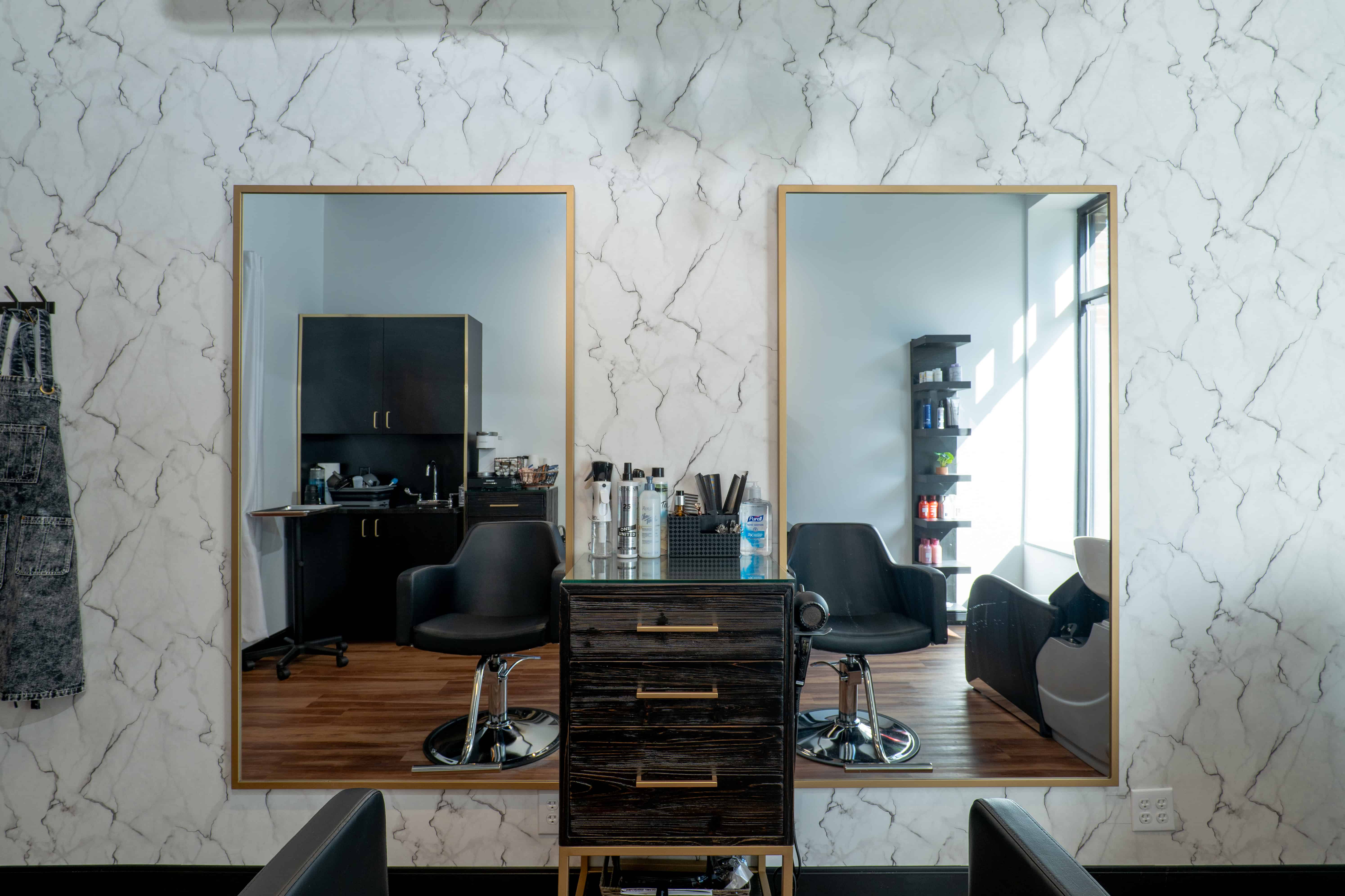 Cosmo salon suite with gold-framed mirrors and styling station
