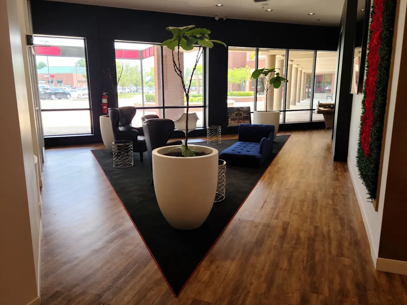 Front lounge at Cosmo Salon Studios Canton with seating, planters and large windows